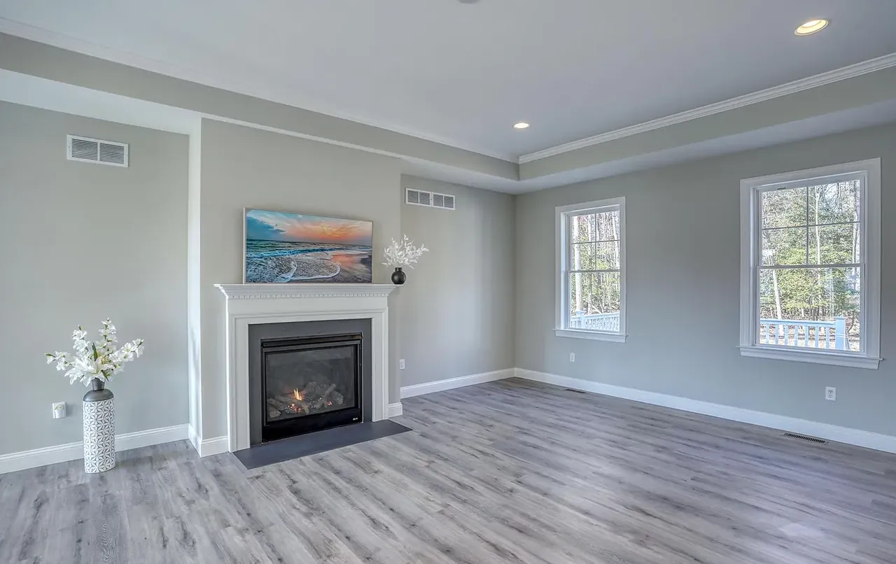 Living room with linear fireplace and crown moulding