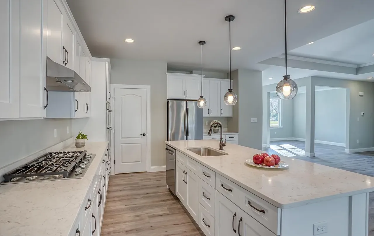 Kitchen island with pendant lights and a gas cooktop