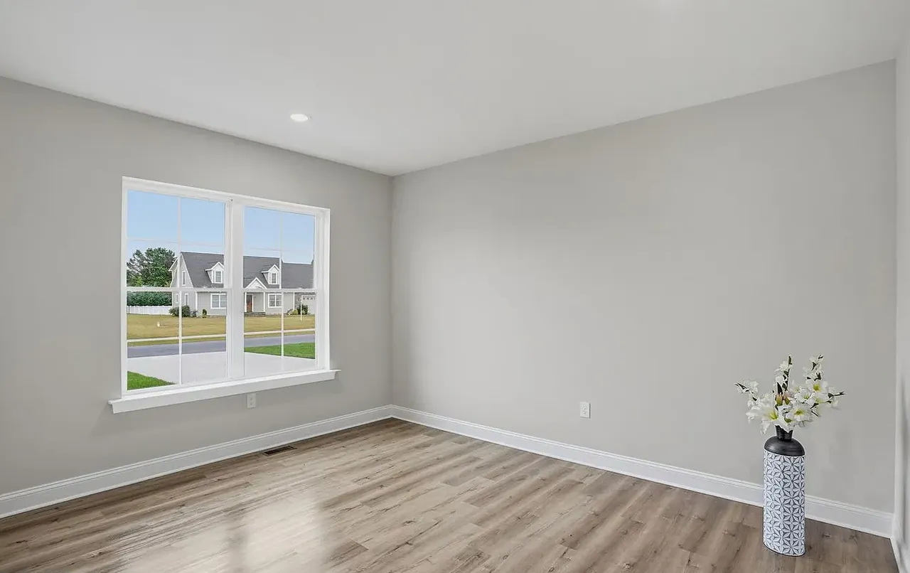 Bedroom with a picture window overlooking the neighbourhood