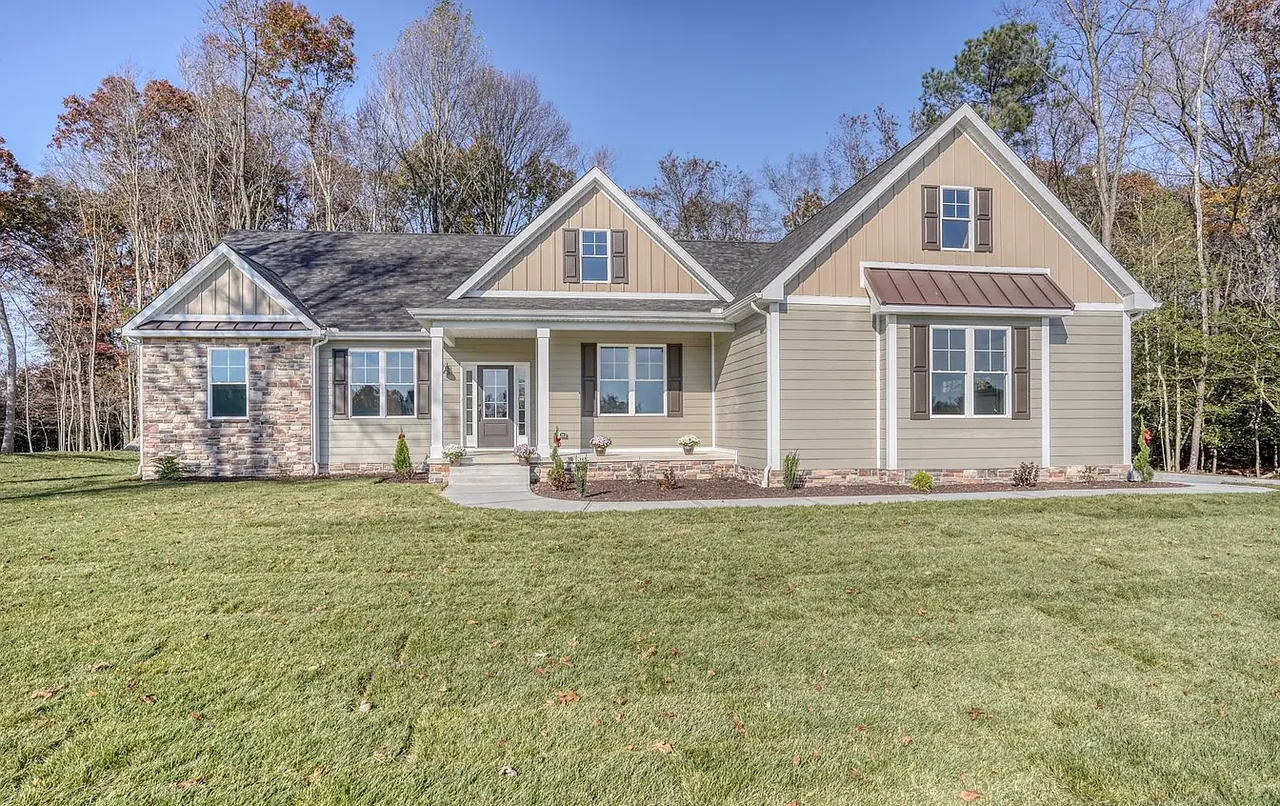 Tan craftsman home with stone veneer skirting and twin front gables
